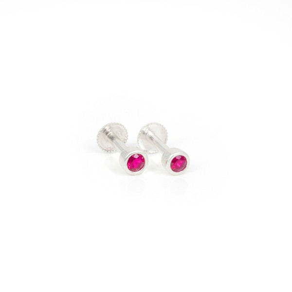 red rubies securely encased in a polished bezel setting.